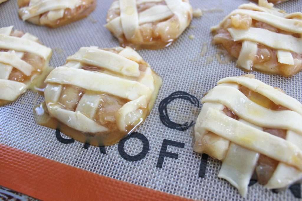 Use a round cookie cutter to cut out the cookies and place on a silicone lined baking sheet. 