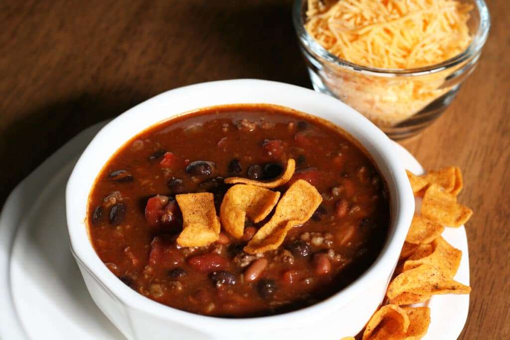 a bowl of chili served with corn chips