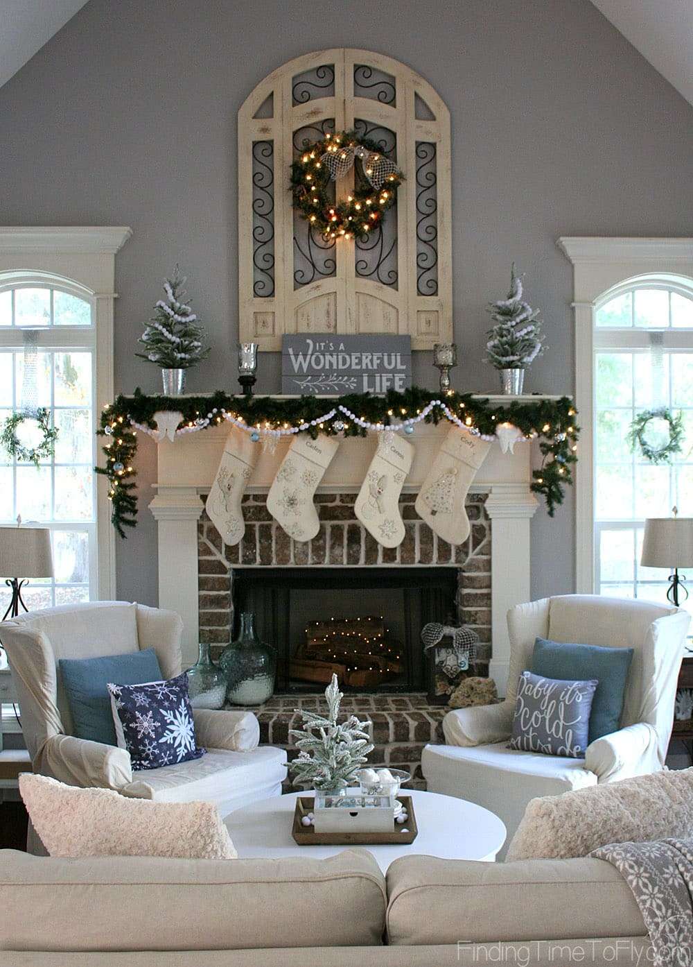 A gorgeous Keeping Room decorated for Christmas in the theme of It's a Wonderful Life with shades of gray, soft whites, jingle bells, angel wings, and snow.