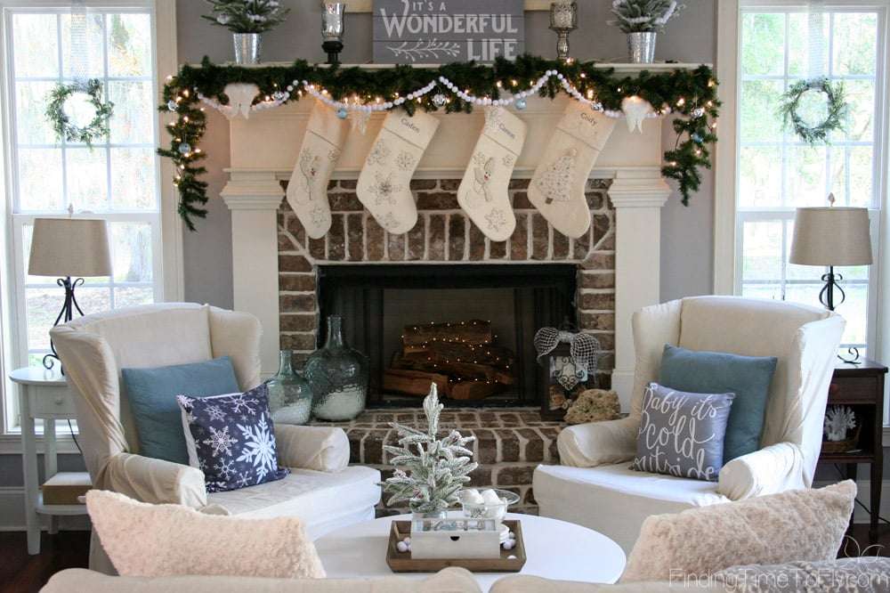 A gorgeous Keeping Room decorated for Christmas in the theme of It's a Wonderful Life with shades of gray, soft whites, jingle bells, angel wings, and snow.