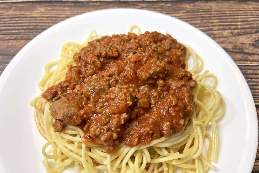 Closeup of spaghetti on a plate covered in sauce