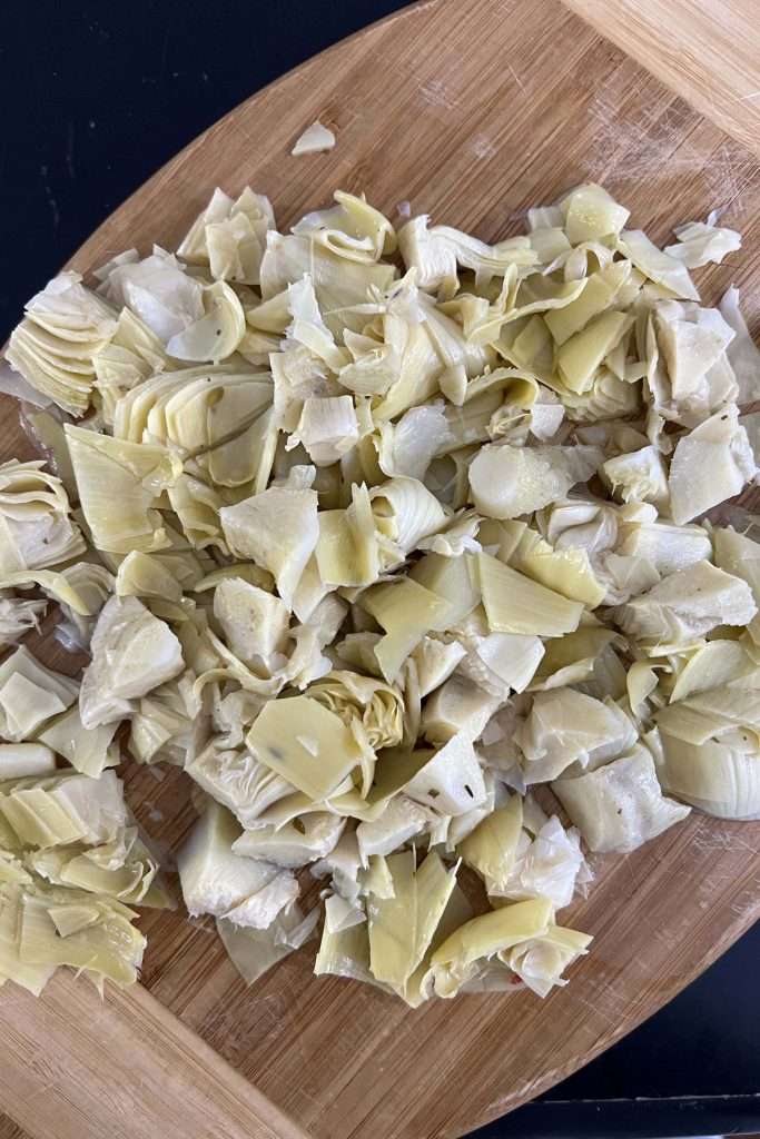 Drain and chop artichoke hearts