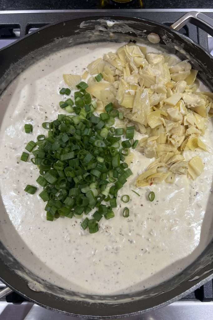 Add artichokes and green onions