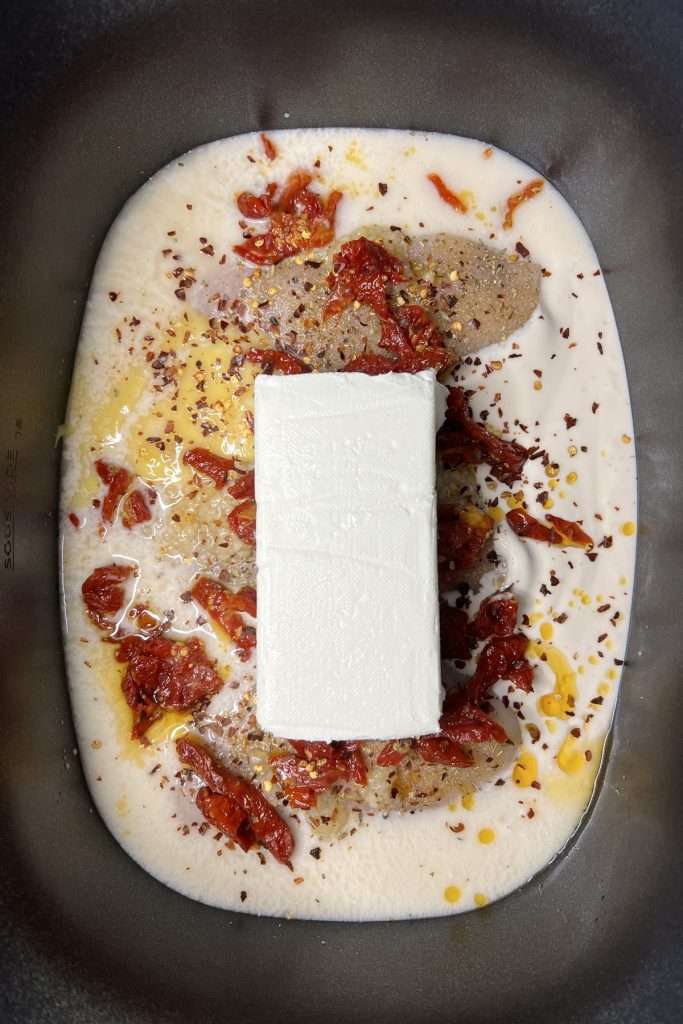 Add crushed red pepper flakes, and a block of cream cheese