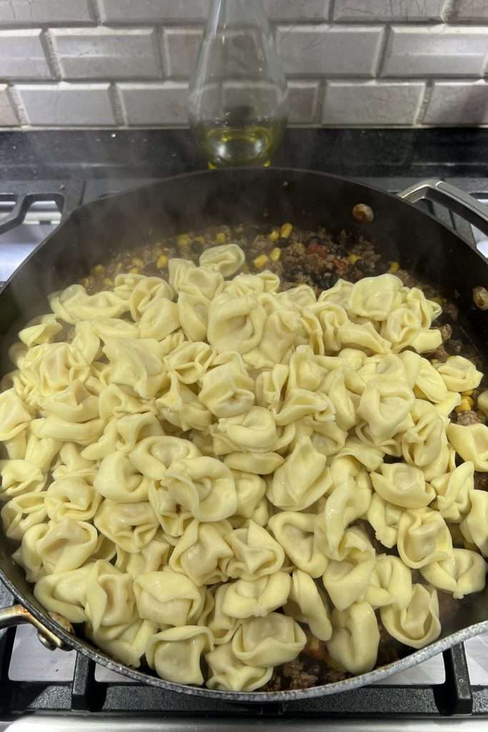 Add cooked tortellini. Stir well.