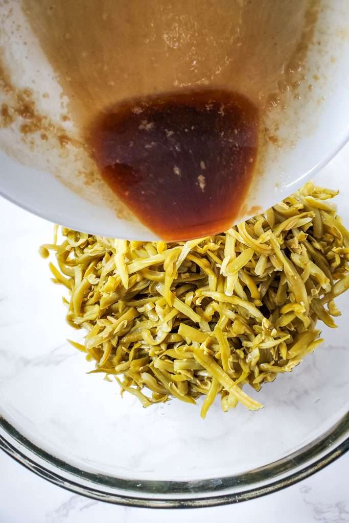 Toss green beans in the sauce