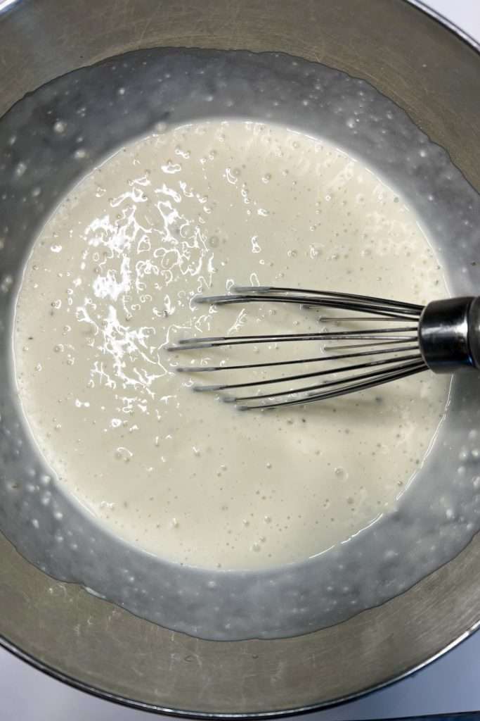 Mix in 2 cups of milk with a whisk