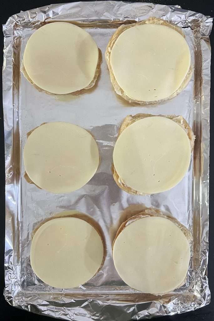 Add a slice of Provolone cheese to each bun.