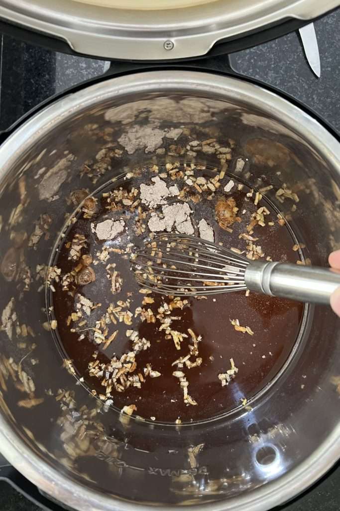 Pour beef broth and seasoning packets into the Instant Pot