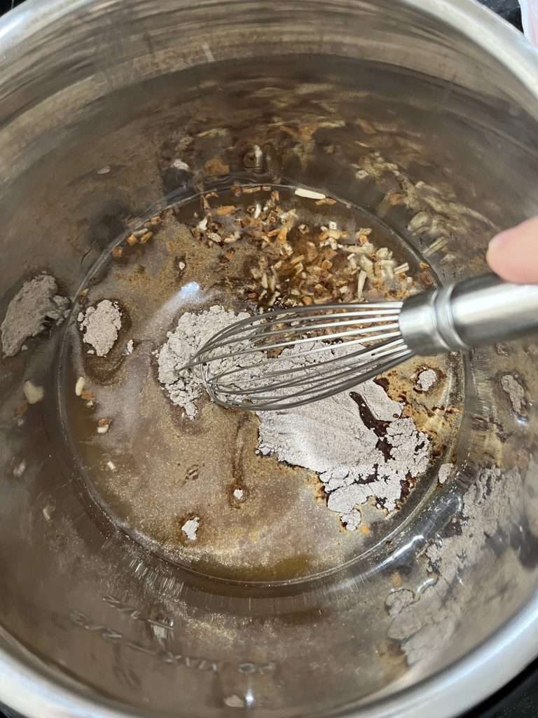 Pour water, au jus mix, brown gravy mix, and onion soup mix into the Instant Pot.
