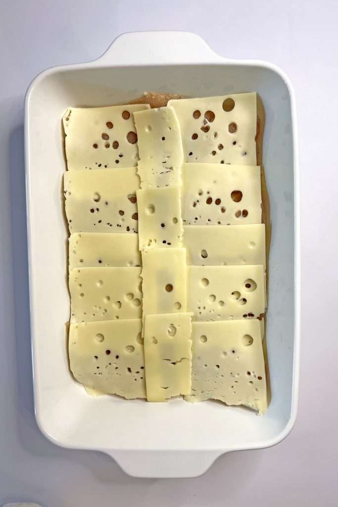 Layer Swiss cheese on top of chicken