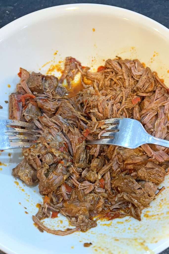 Shred the beef using 2 forks