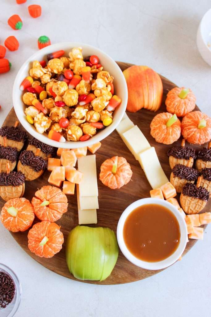 Next add the Mandarin Orange Pumpkins and Nutter Butter Acorn Cookies and cheese