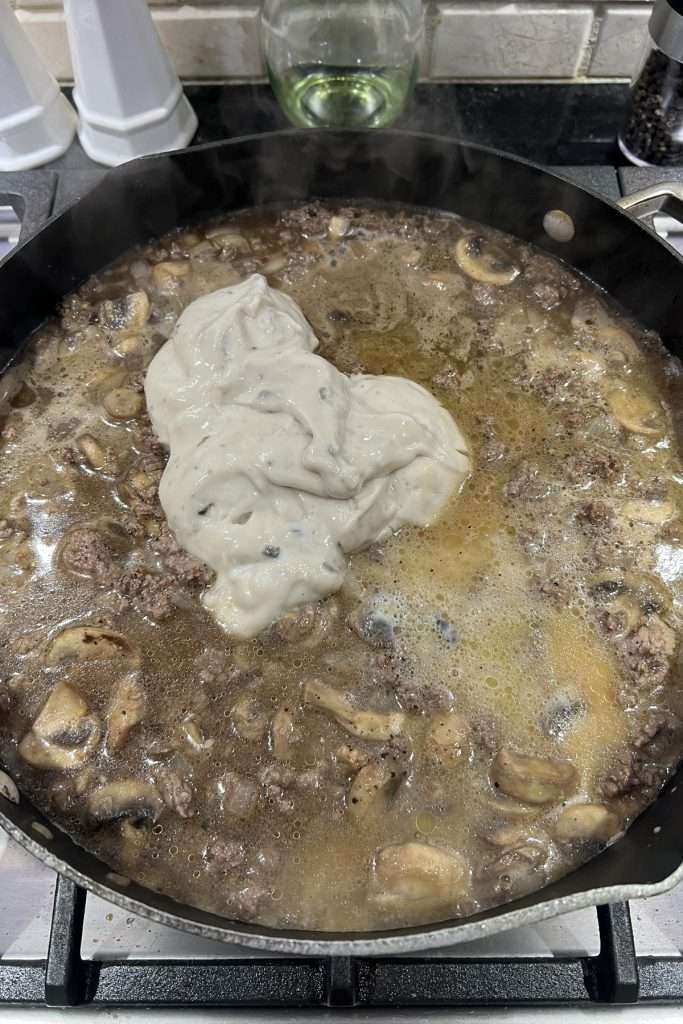 Add cream of mushroom soup, beef broth, and worcestershire sauce.