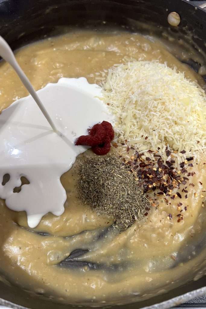 Add seasonings, tomato paste, parmesan cheese, and heavy cream