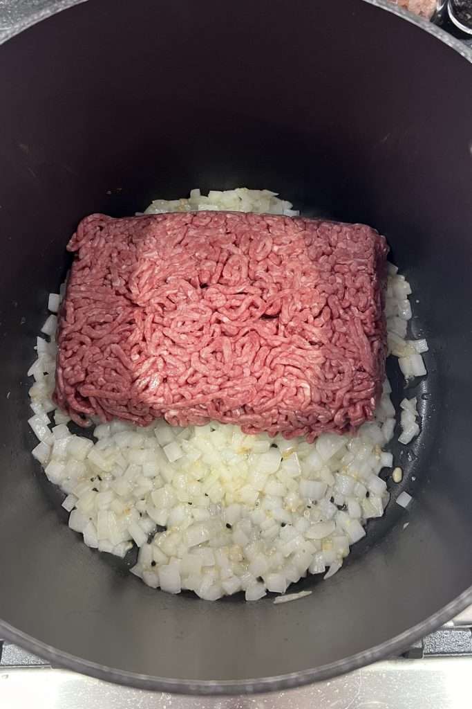 Add ground beef. Cook and drain excess grease.