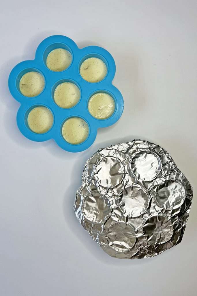 Cover the molds tightly with aluminum foil