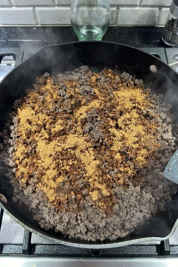 Cook ground beef, drain excess grease, add taco seasoning