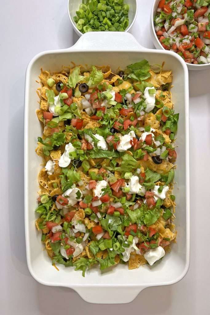 Top with fresh ingredients such as shredded lettuce, pico de gallo, green onions, and sour cream.