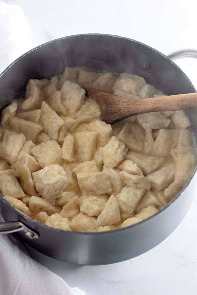 Add the biscuit pieces one at a time