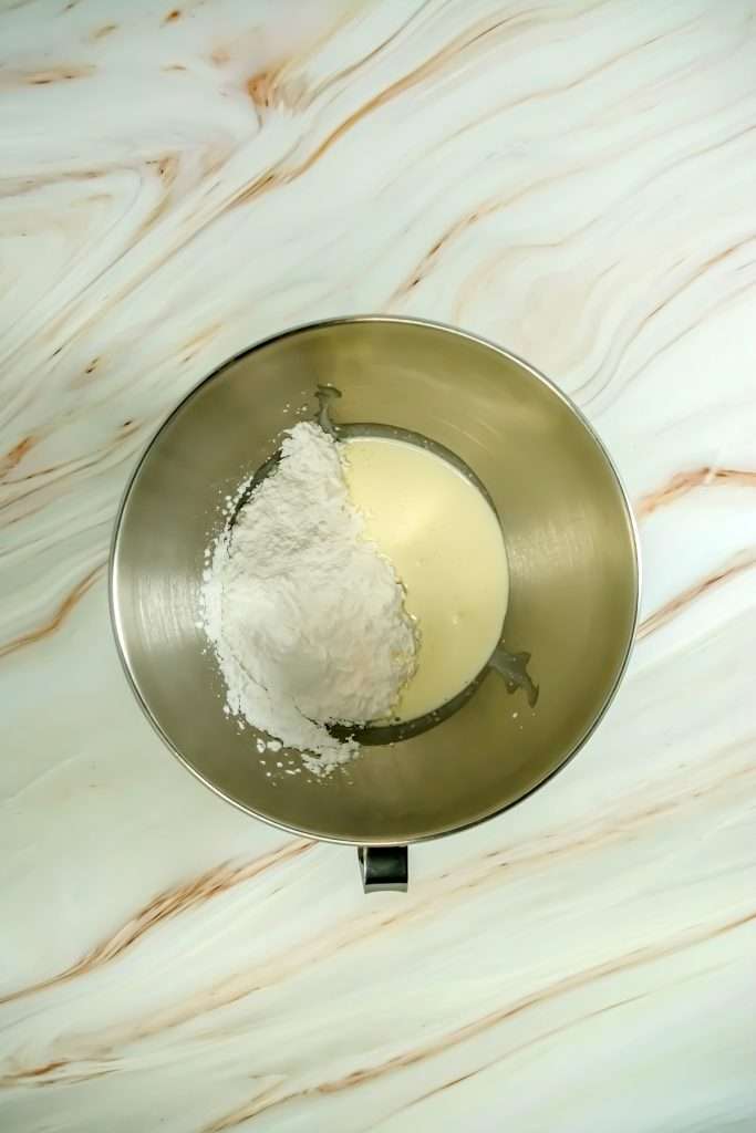 Begin whipping the heavy cream and powdered sugar together in a large bowl