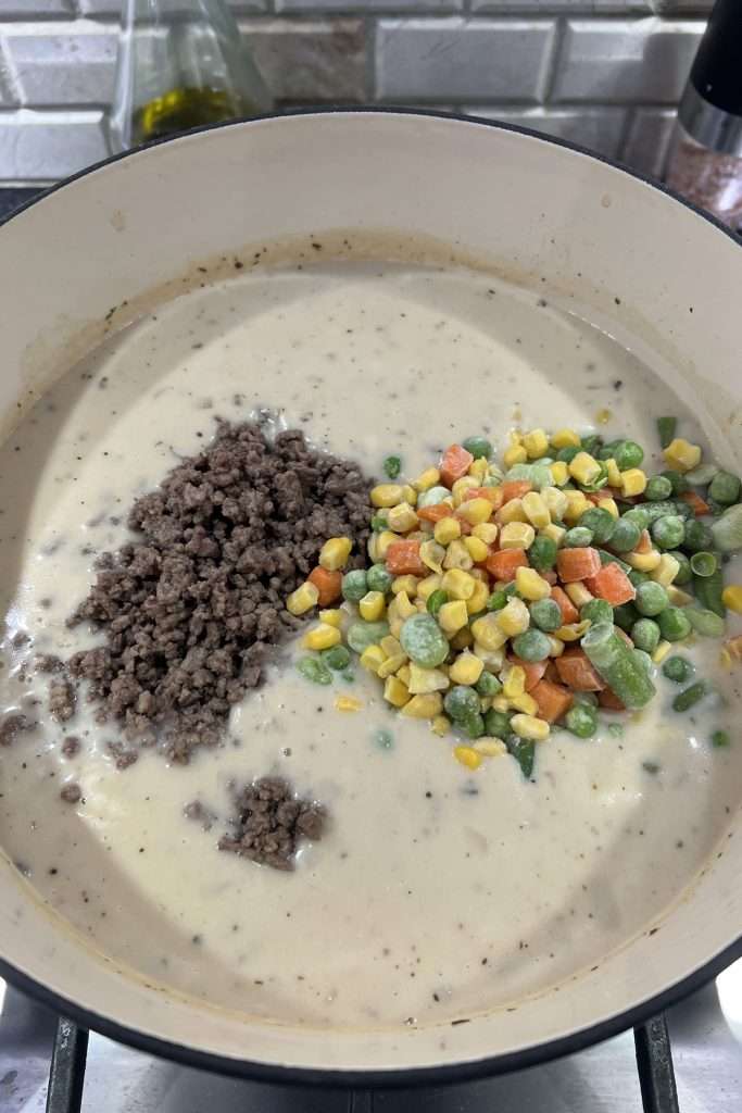 Add cooked beef and frozen vegetables
