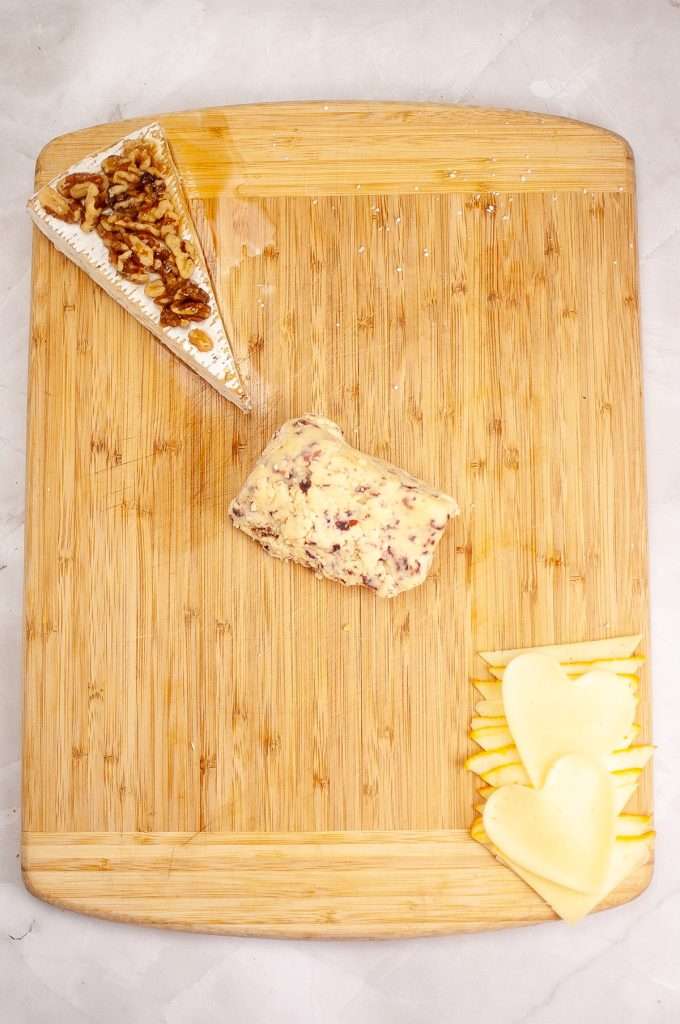 Arrange cheeses on board