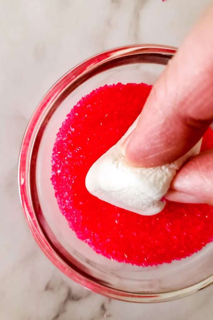 Dip the cut side into the pink sanding sugar