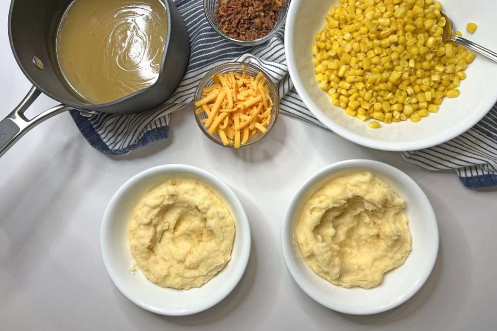 Scoop mashed potatoes into a bowl.