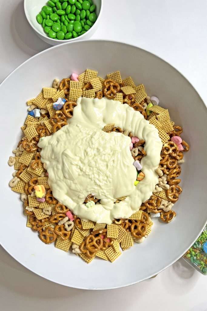 Pour melted chocolate over snack mix