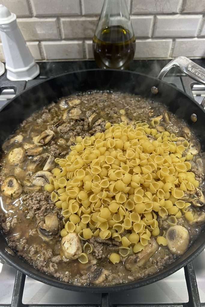 Add pasta and beef broth