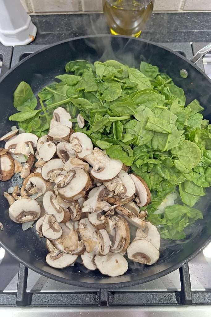 Add chopped spinach and sliced mushrooms