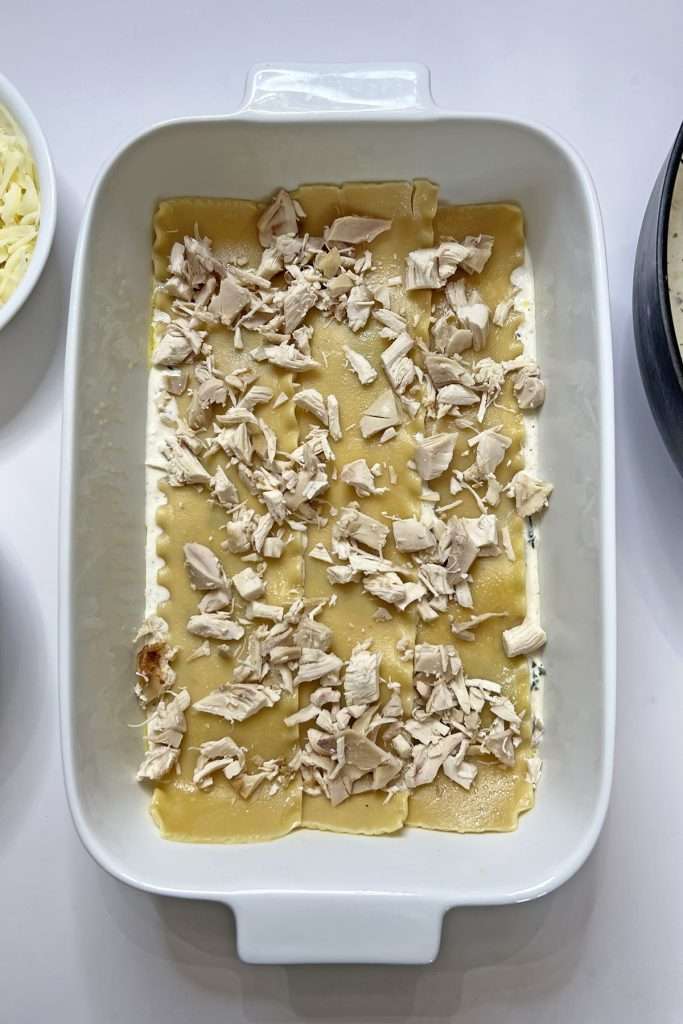 Add a layer of cooked and chopped chicken.