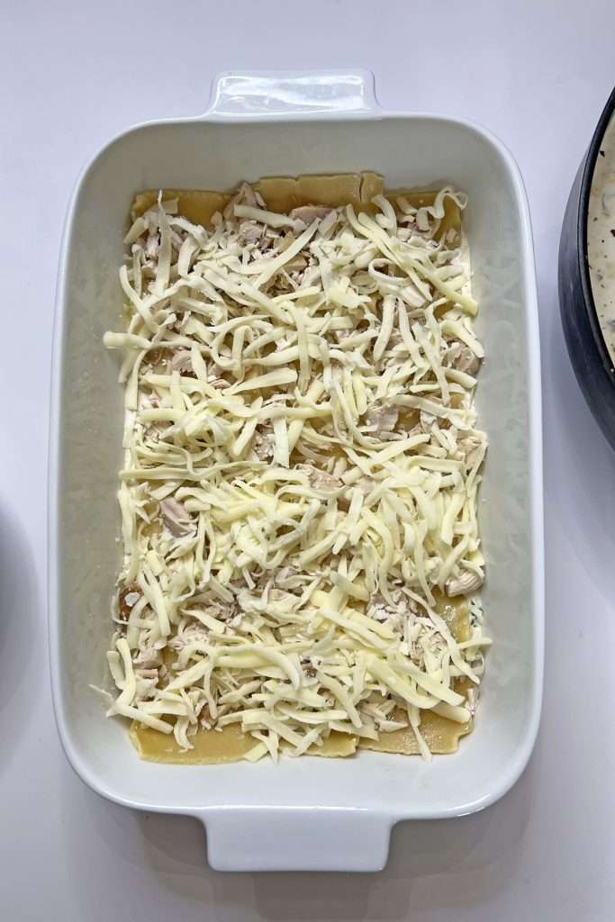 Add a layer of shredded mozzarella cheese.