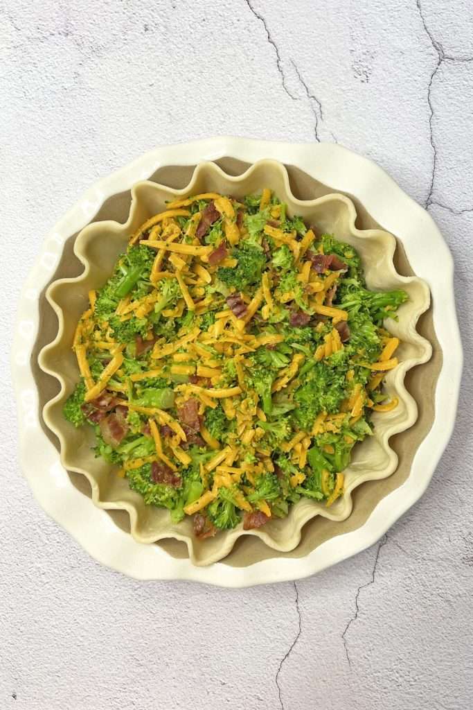 Pour broccoli mixture into pie crust and spread it out evenly.