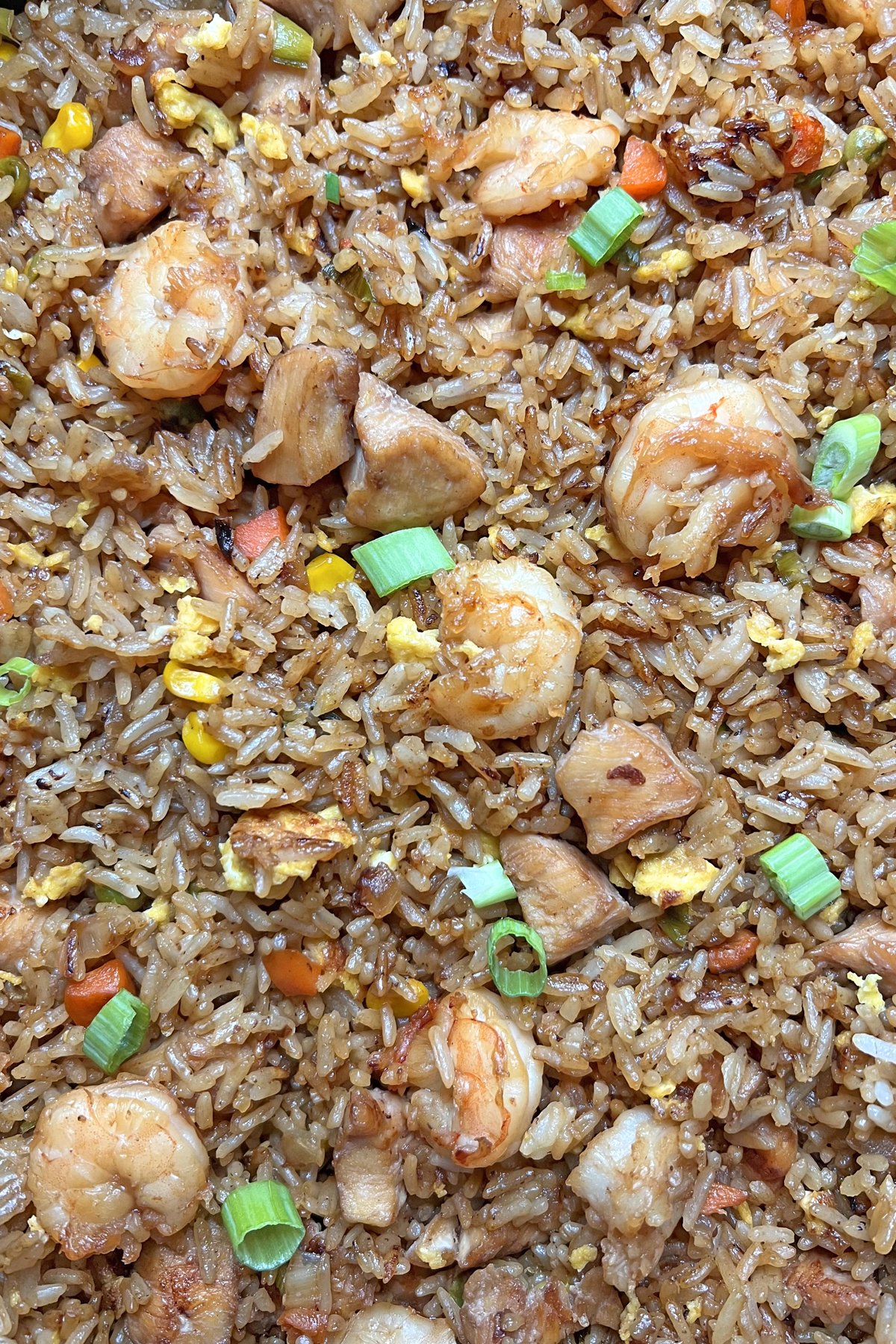 close-up of shrimp and chicken fried rice in pan