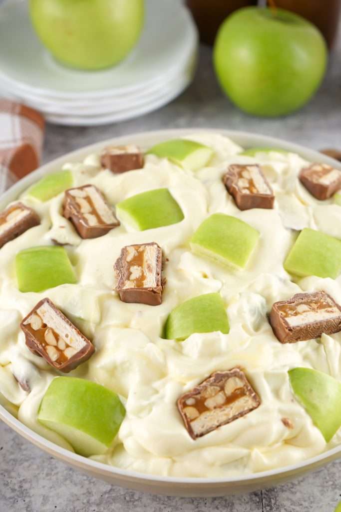 Stir to combine and top with reserved apple and candy bar pieces