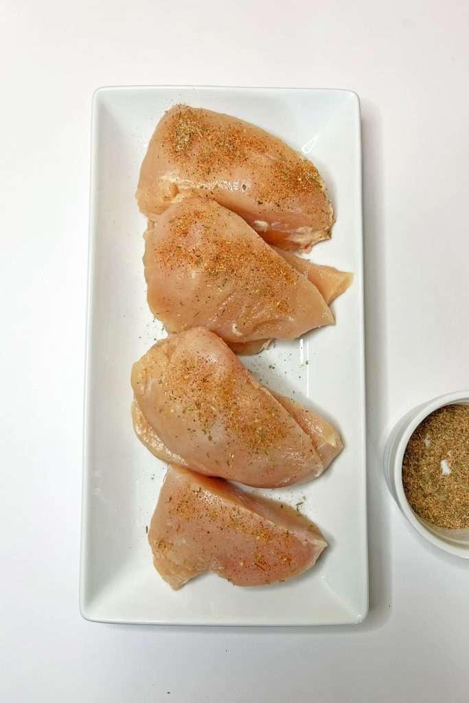 Season both sides of chicken