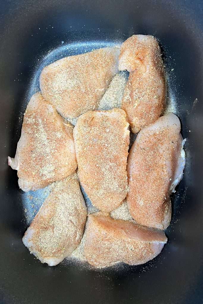 Place well seasoned chicken pieces in the crockpot