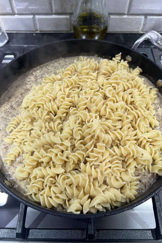 Add cooked noodles. Stir to combine.