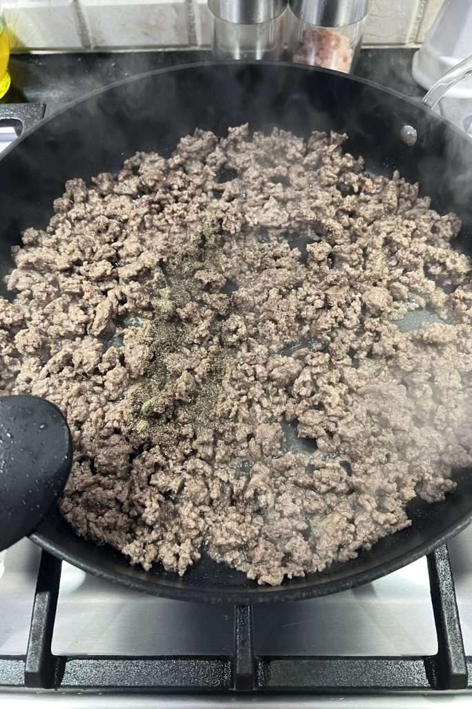 Brown ground beef, drain excess grease, and season.