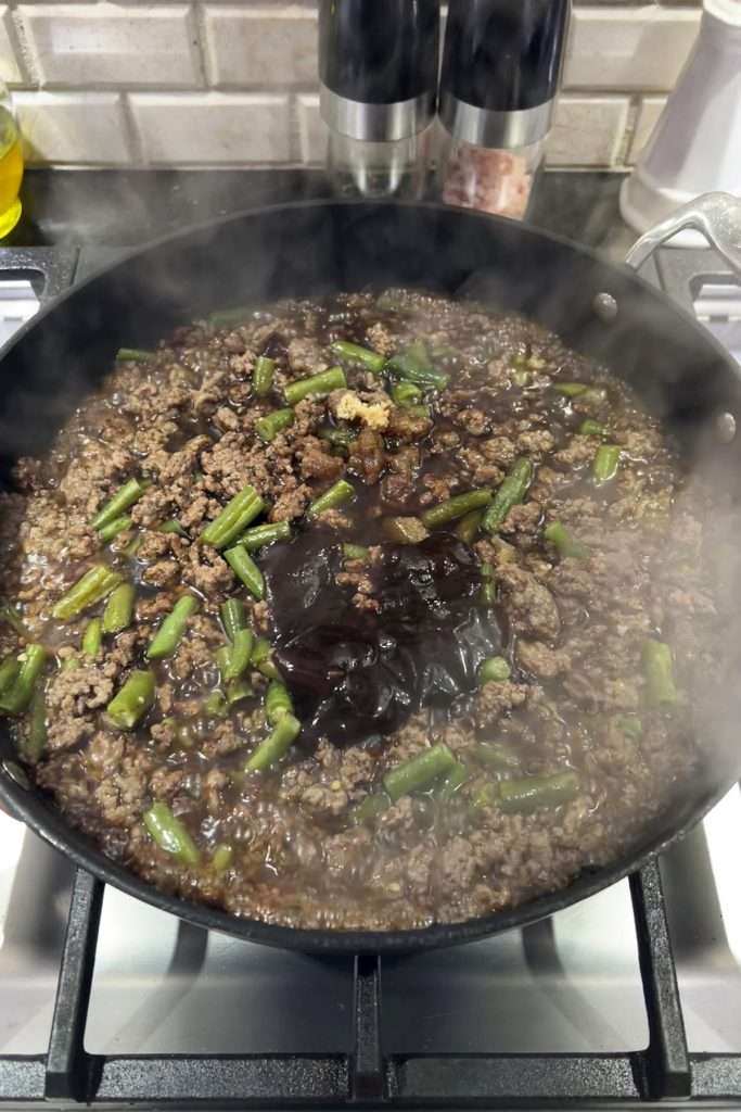 Add soy sauce and hoisin sauce to pan.