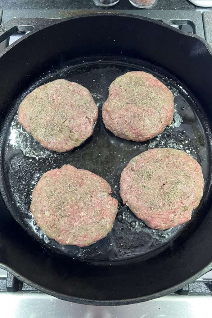 Season patties and cook.