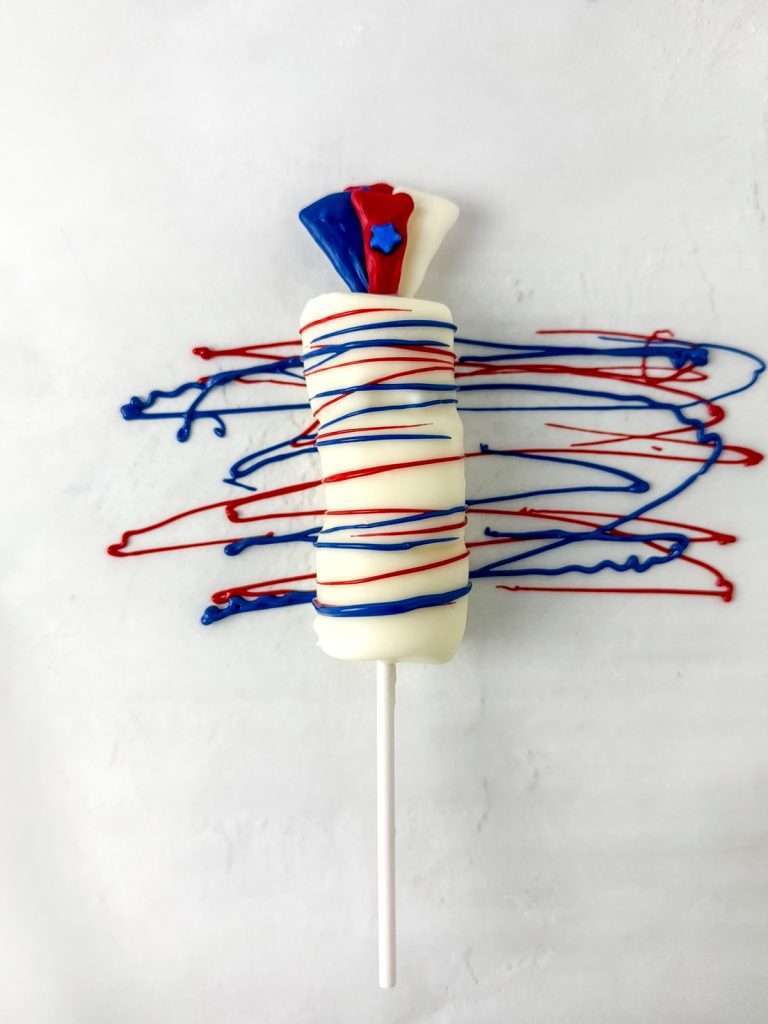 Pipe red and blue chocolate onto the pops.