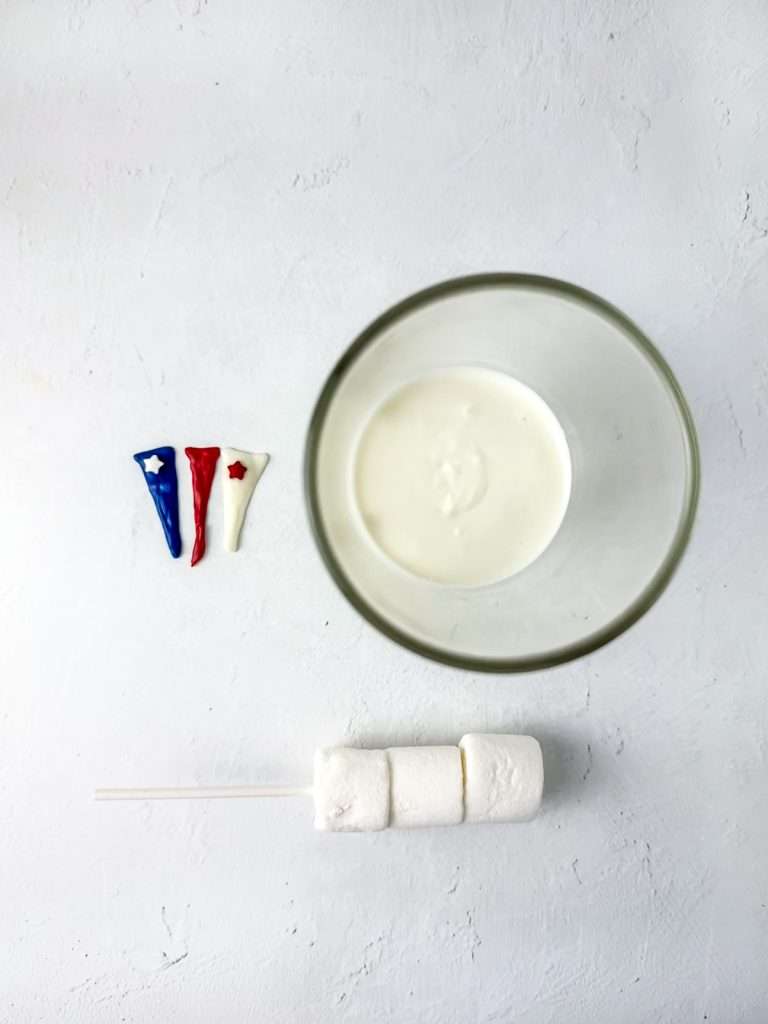 Melt white chocolate and place in a tall glass.