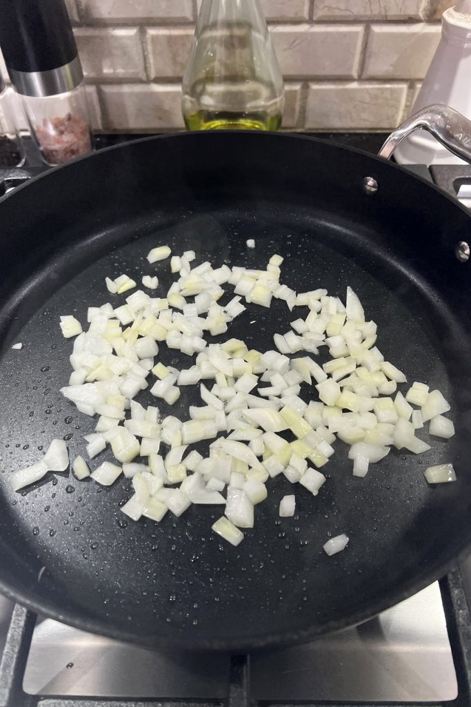 Diced onions in a frying pan