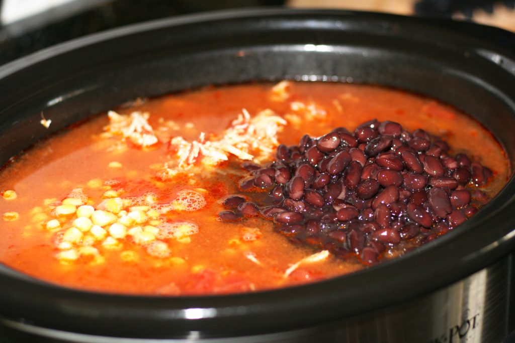 Add canned beans and frozen corn.