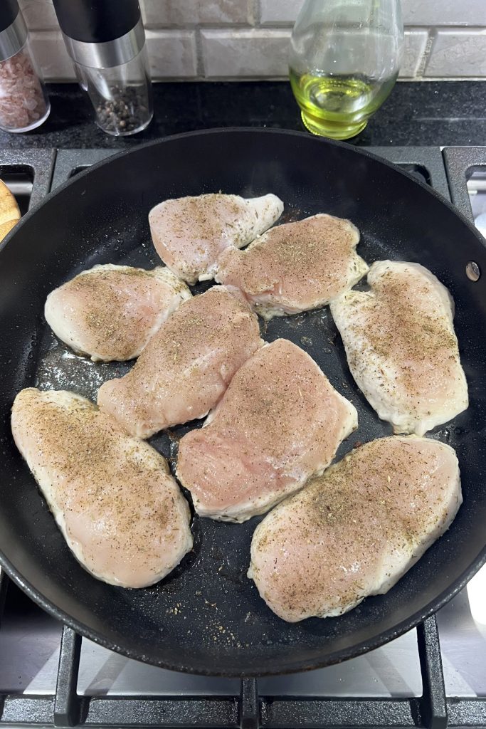 Season both sides of the chicken breasts.