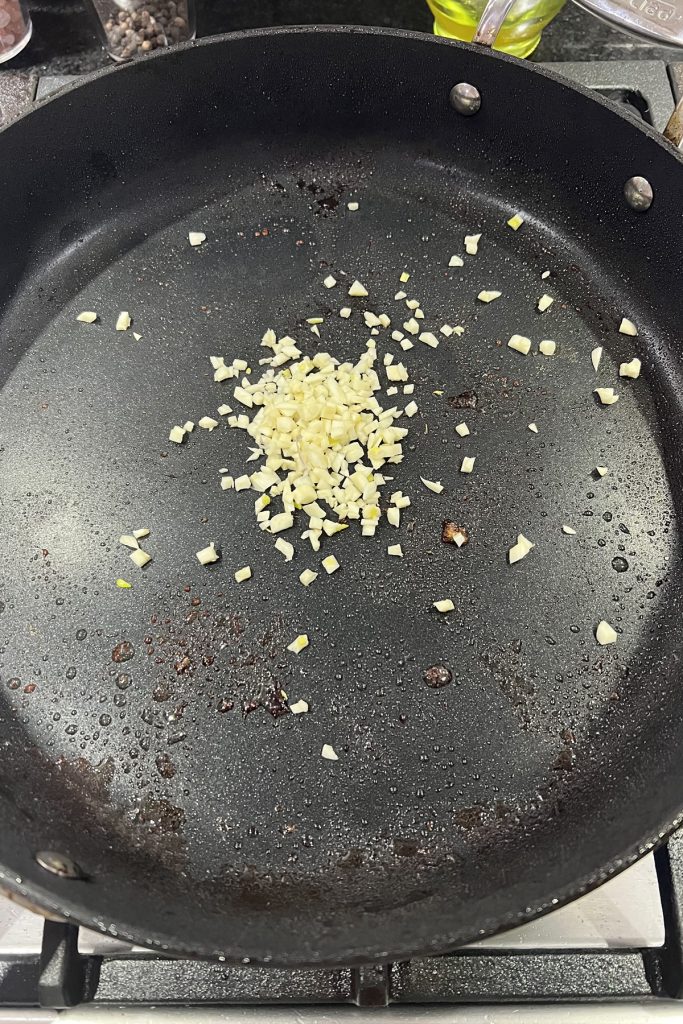 Add minced garlic to the pan.