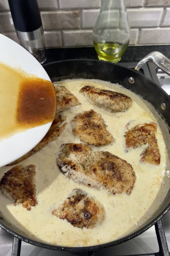 Place chicken breasts and any sauce from the plate back into the skillet.